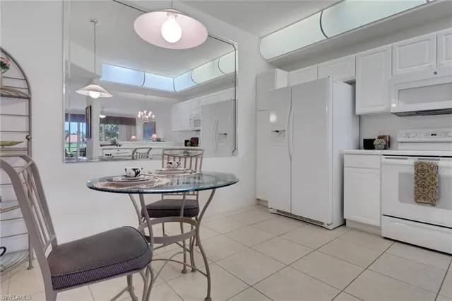 a kitchen with cabinets and chairs