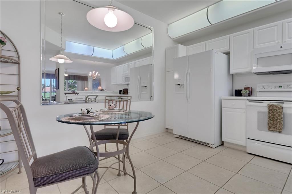 23790 Clear Spring Court, Unit 1603 Estero, FL 34135 - Photo 8 of 39 a kitchen with cabinets and chairs