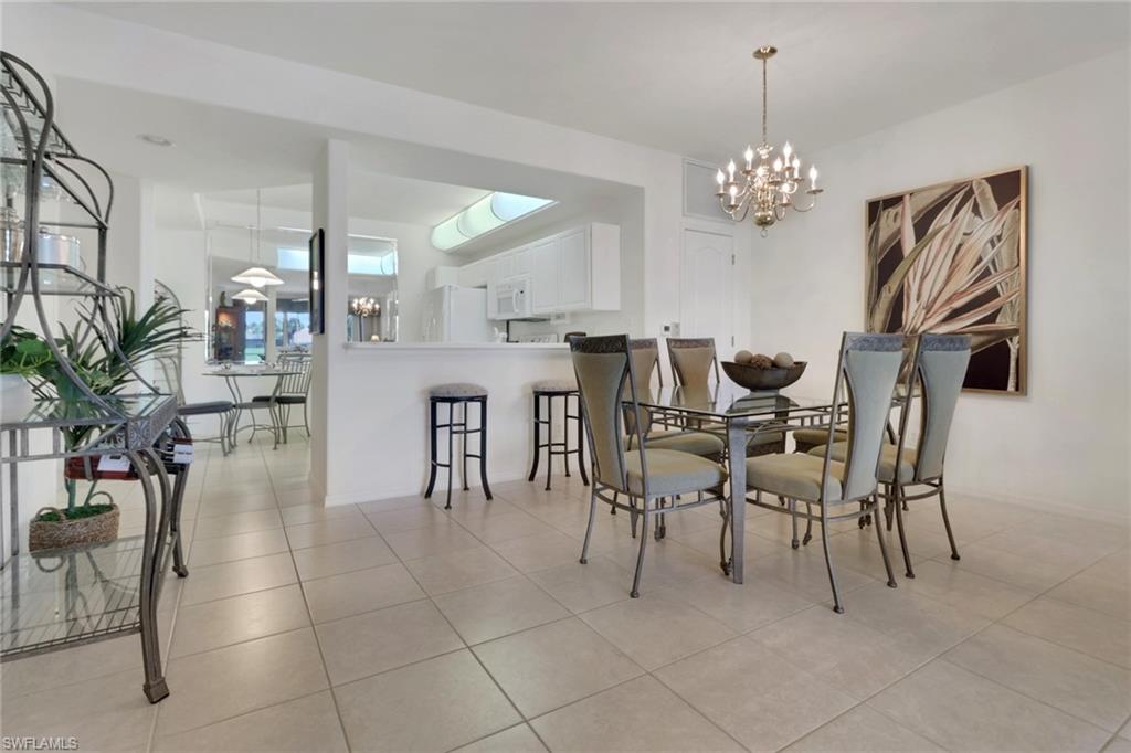23790 Clear Spring Court, Unit 1603 Estero, FL 34135 - Photo 10 of 39 a view of a dining room with furniture and chandelier