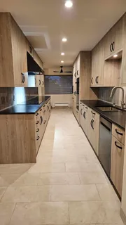 a large kitchen with stainless steel appliances granite countertop a stove and a sink