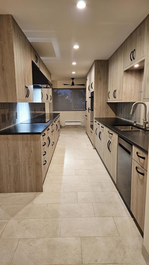 a large kitchen with stainless steel appliances granite countertop a stove and a sink