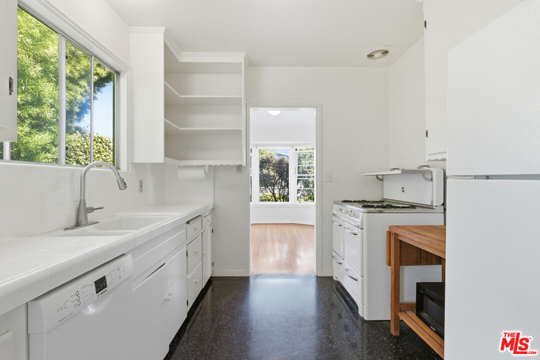 1019 Pine Street Santa Monica, CA 90405 - Photo 14 of 36 a kitchen with a sink stove and cabinets
