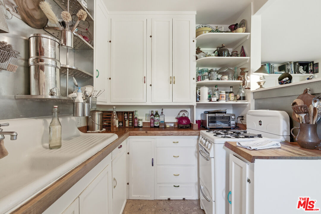 1019 Pine Street Santa Monica, CA 90405 - Photo 26 of 36 a kitchen with cabinets and window