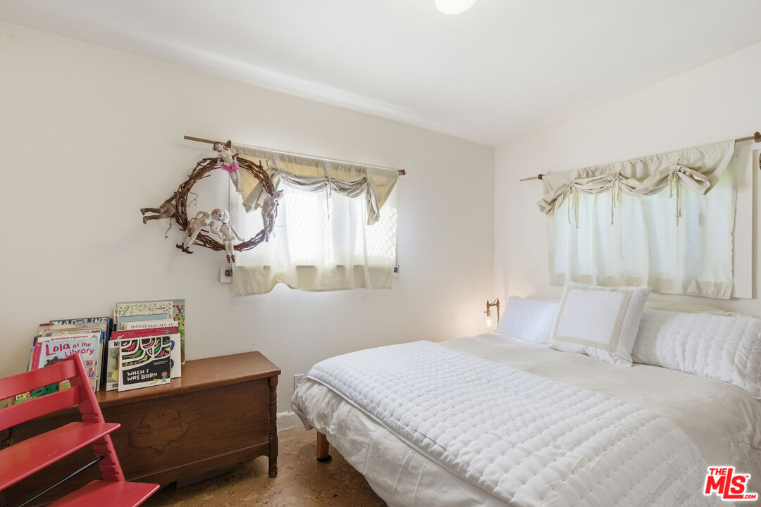 1019 Pine Street Santa Monica, CA 90405 - Photo 28 of 36 a bedroom with a bed and a chandelier
