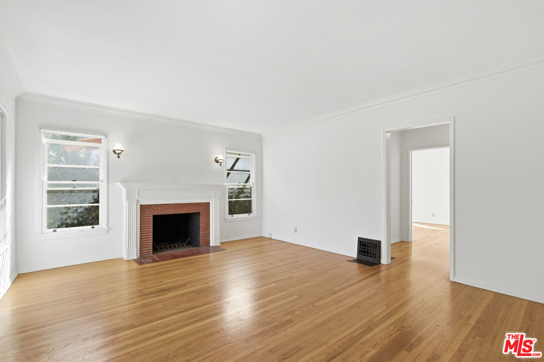 1019 Pine Street Santa Monica, CA 90405 - Photo 4 of 36 a view of an empty room with wooden floor fireplace and a window