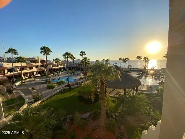 a view of a backyard with a patio and swimming pool