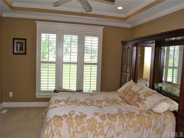 113 Jackson Ridge Court Willow Spring, NC 27592 - Photo 8 of 25 a bedroom with a large bed and a large window
