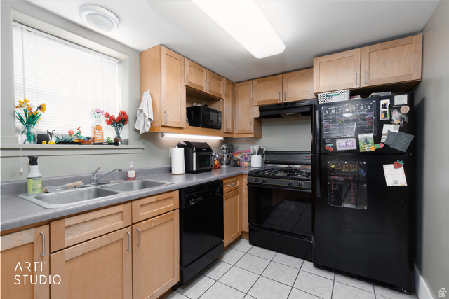 265 West 200 North Logan, UT 84321 - Photo 17 of 31 Kitchen with light wood finish cabinetry, black appliances, light tile patterned floors, and light countertops