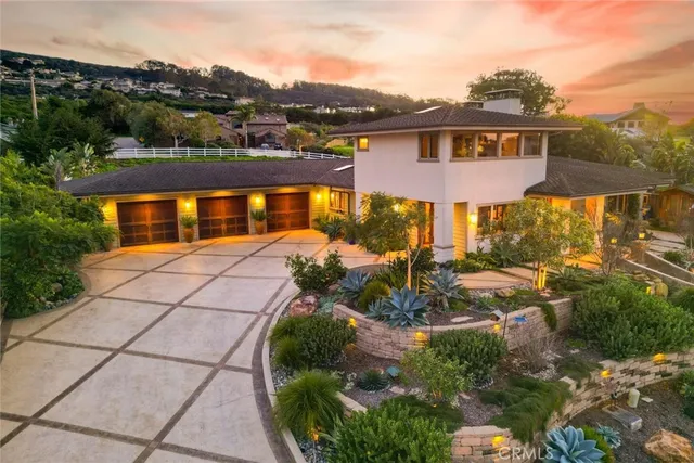 an aerial view of residential houses with outdoor space and ocean view