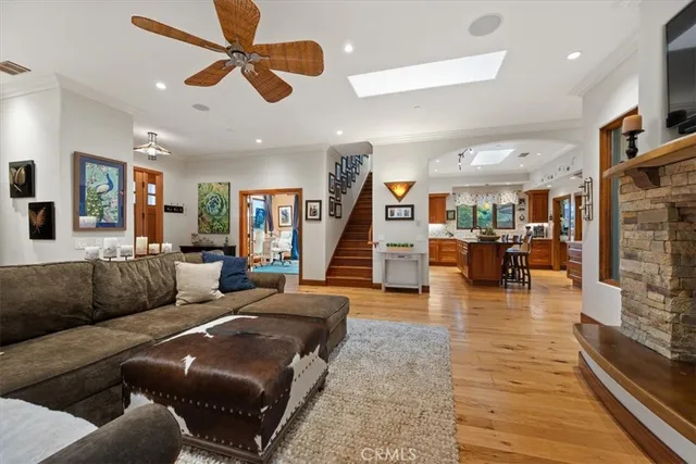 a living room with fireplace furniture and a chandelier