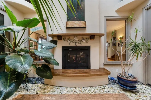 a kitchen with stainless steel appliances granite countertop a kitchen island a stove a sink a dining table and chairs