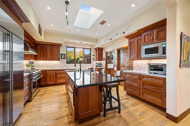 a kitchen with granite countertop a stove and a sink