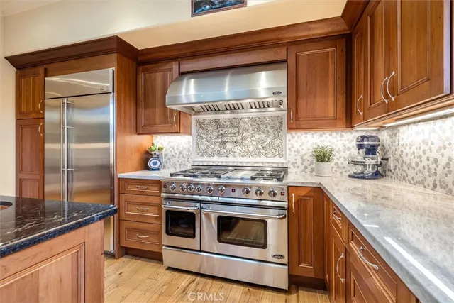 a kitchen with granite countertop a sink and a wooden cabinets
