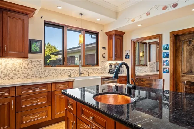 a kitchen with stainless steel appliances granite countertop a sink stove and cabinets