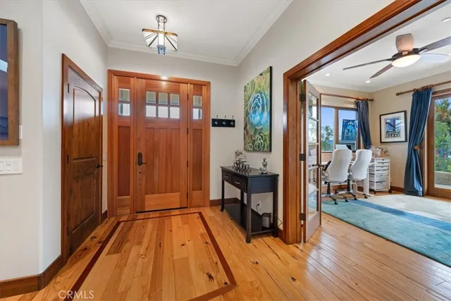 a bedroom with a bed and a large window with the outer view