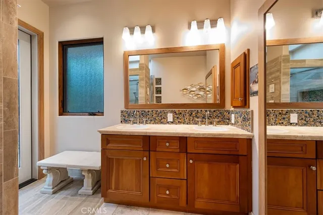 a bathroom with a granite countertop sink a toilet and shower