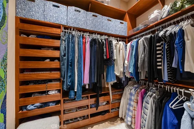 a bedroom with a large bed and a flat tv