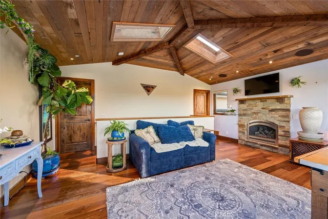 a front view of a house with a yard and potted plants