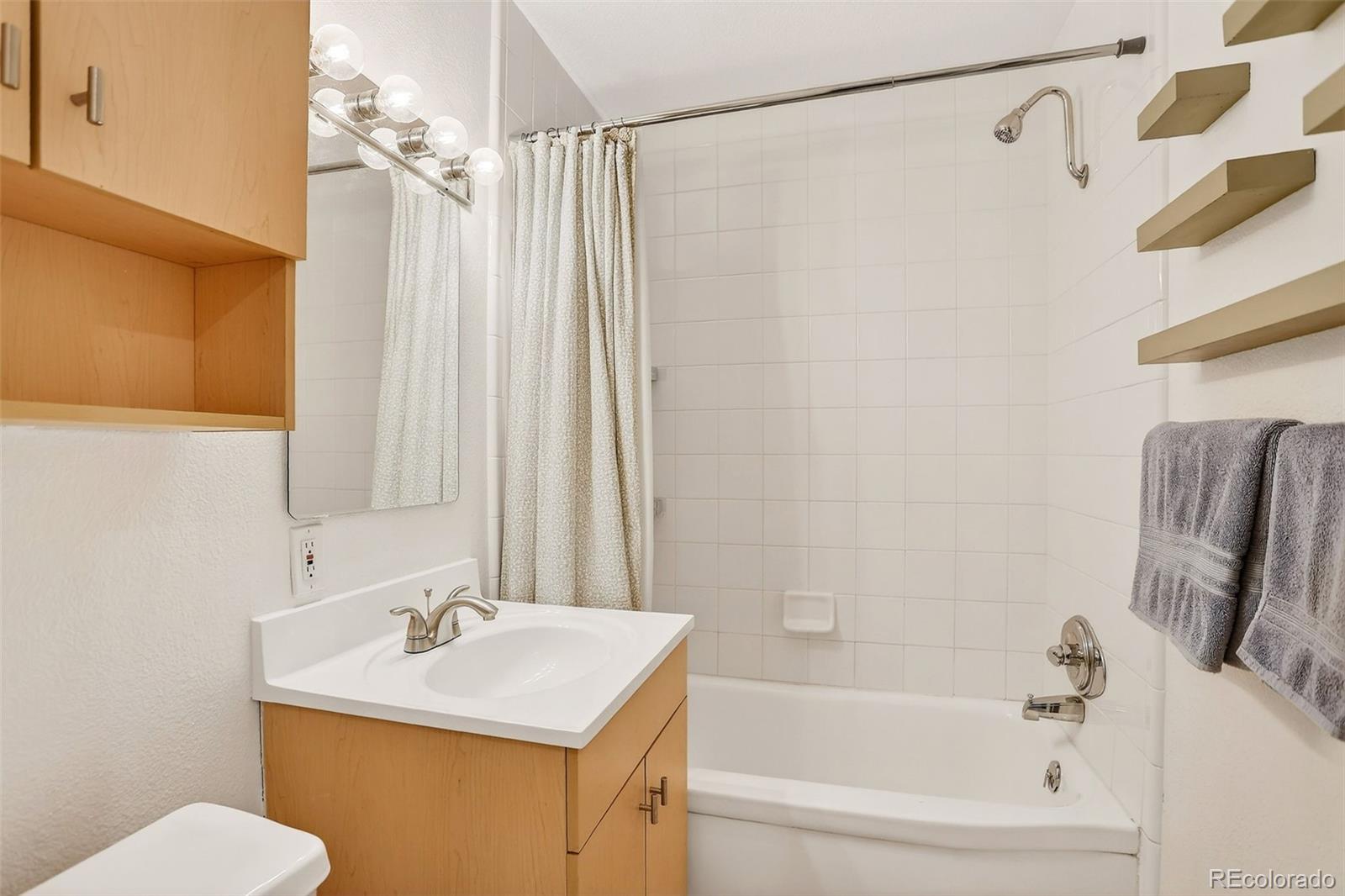2500 South York Street, Unit 401 Denver, CO 80210 - Photo 14 of 30 a bathroom with a sink toilet and shower