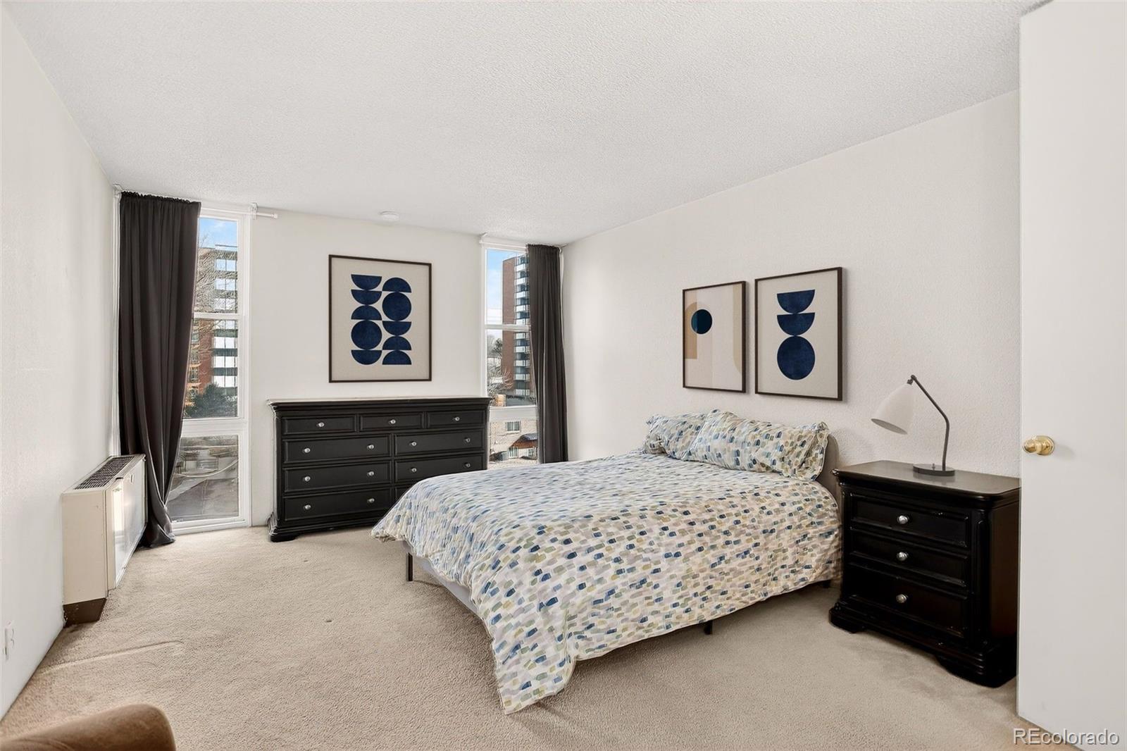 2500 South York Street, Unit 401 Denver, CO 80210 - Photo 15 of 30 a bedroom with a bed and a dresser