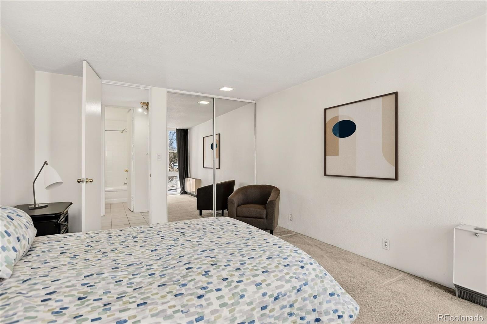 2500 South York Street, Unit 401 Denver, CO 80210 - Photo 17 of 30 a bedroom with a bed and a couch