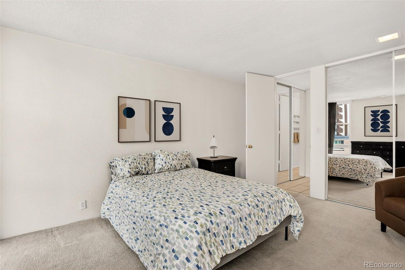 2500 South York Street, Unit 401 Denver, CO 80210 - Photo 18 of 30 a bedroom with a large bed and a couch
