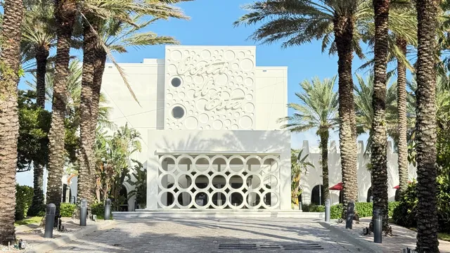 a sign board with buildings in the background