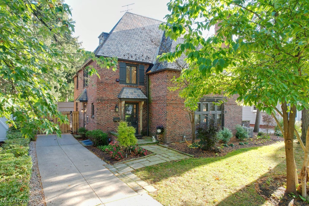 3077 Huntington Road Cleveland, OH 44120 - Photo 1 of 37 Tudor home featuring a high end roof, brick siding, and a front lawn