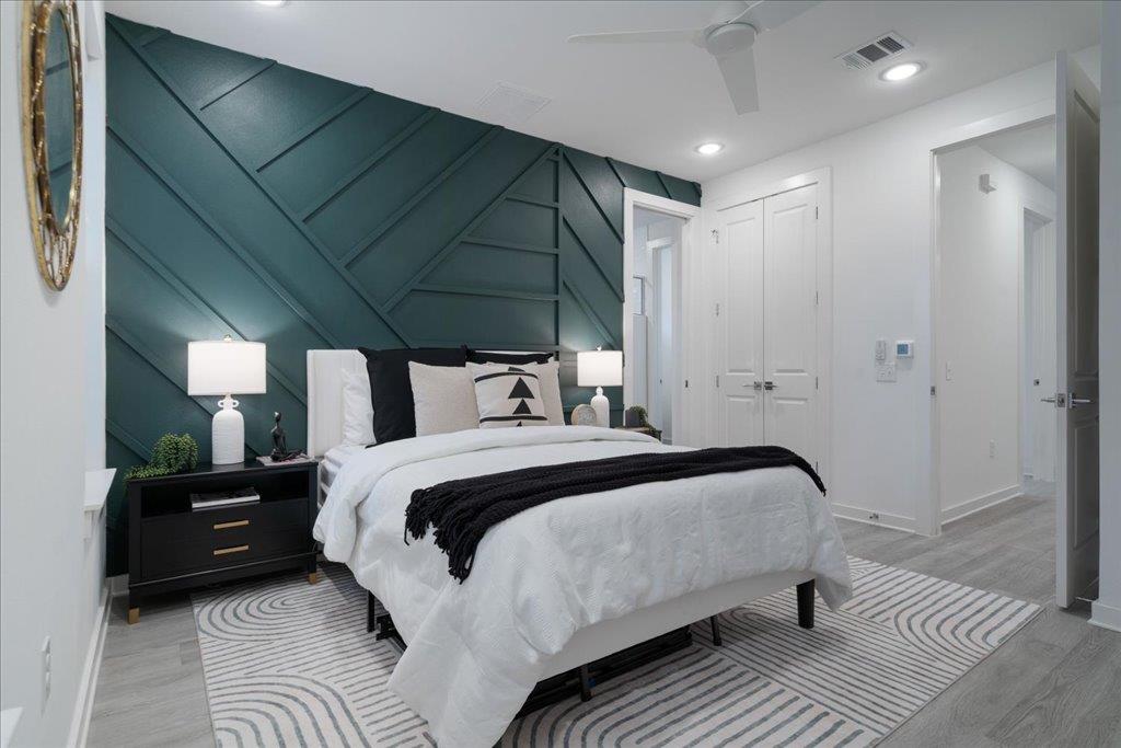 2624 Metcalfe Road, Unit 10 Austin, TX 78741 - Photo 12 of 27 Bedroom with a decorative wall, recessed lighting, a closet, a ceiling fan, and an accent wall