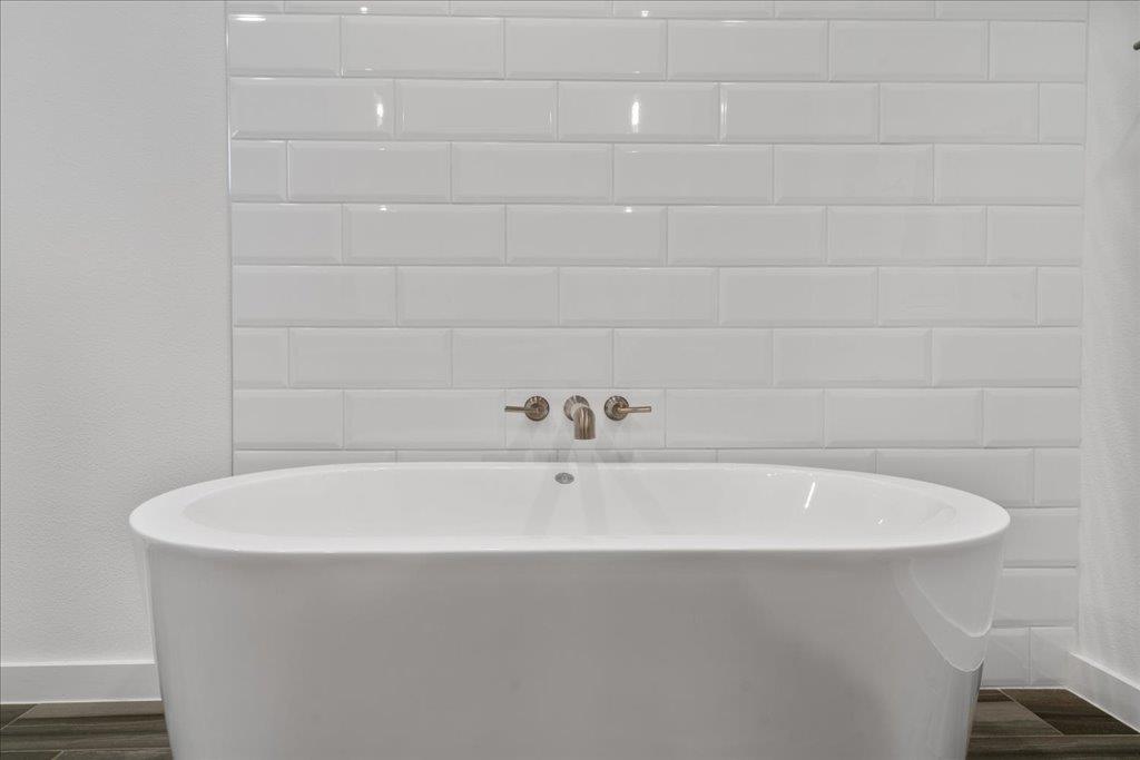 2624 Metcalfe Road, Unit 10 Austin, TX 78741 - Photo 15 of 27 Bathroom featuring a soaking tub and wood tiled floors