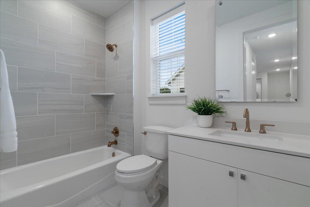 2624 Metcalfe Road, Unit 10 Austin, TX 78741 - Photo 19 of 27 Full bath with shower / washtub combination, vanity, and tile patterned floors