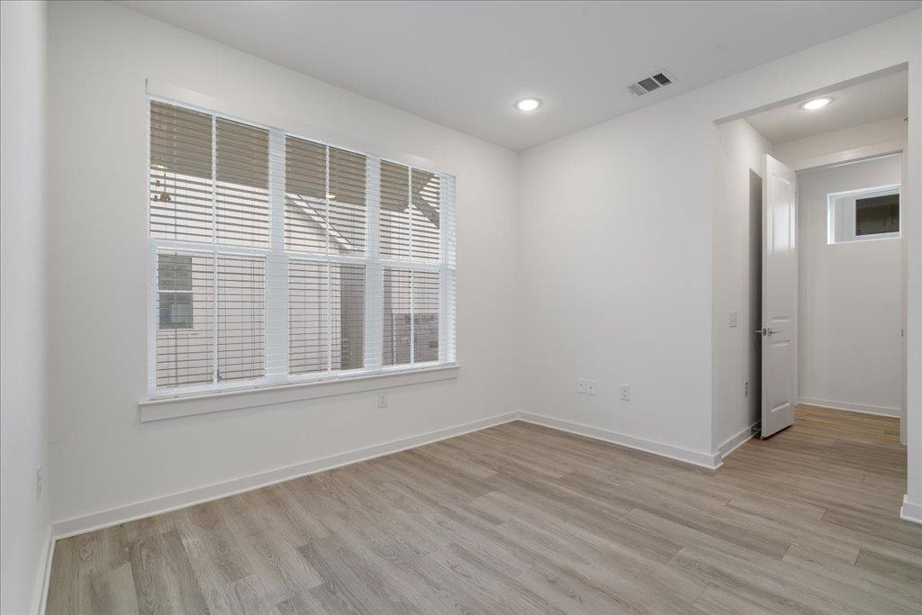 2624 Metcalfe Road, Unit 10 Austin, TX 78741 - Photo 20 of 27 Unfurnished room with light wood finished floors and recessed lighting