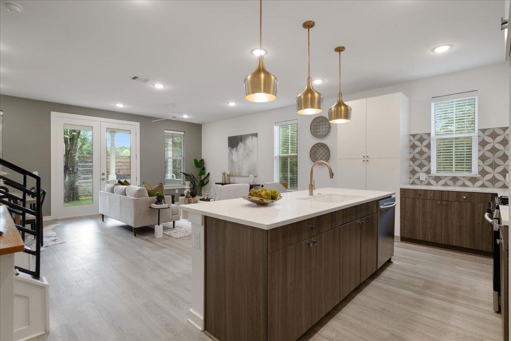 2624 Metcalfe Road, Unit 10 Austin, TX 78741 - Photo 27 of 27 Kitchen featuring an island with sink, open floor plan, hanging light fixtures, healthy amount of natural light, and recessed lighting