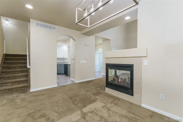 a view of a fireplace in an empty room