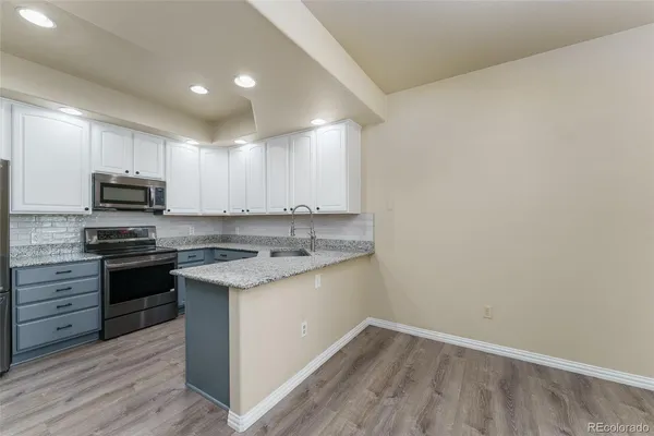a kitchen with a sink stove and microwave