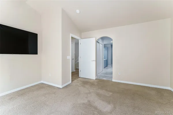 a view of a livingroom with an empty space and a window