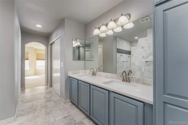 a bathroom with a sink vanity and a mirror