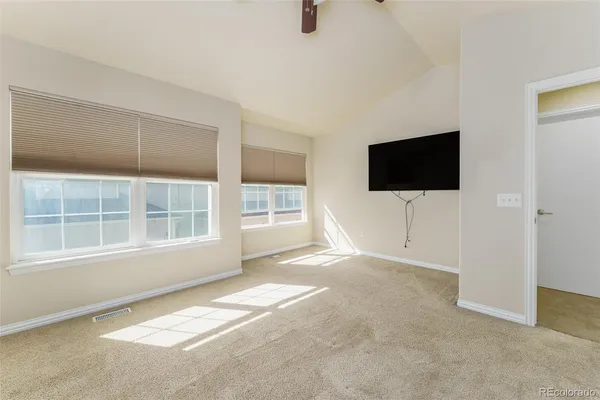 a view of a livingroom with a flat screen tv and windows