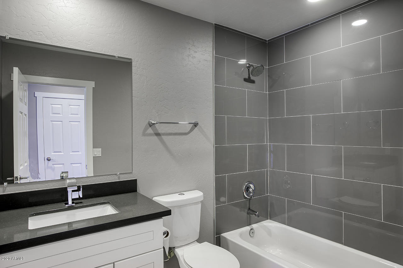 1423 East Granada Road Phoenix, AZ 85006 - Photo 18 of 25 a bathroom with a sink a toilet and mirror