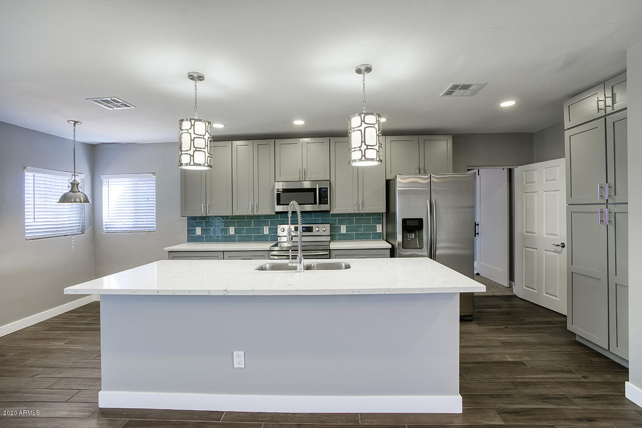 1423 East Granada Road Phoenix, AZ 85006 - Photo 7 of 25 a view of kitchen with refrigerator stove and wooden floor