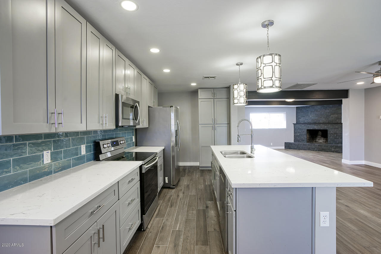 1423 East Granada Road Phoenix, AZ 85006 - Photo 8 of 25 a kitchen with kitchen island a sink stainless steel appliances and cabinets