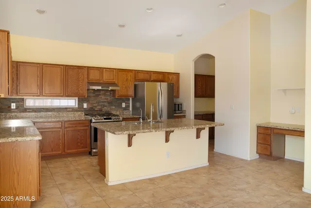 a kitchen with stainless steel appliances granite countertop a stove and a sink