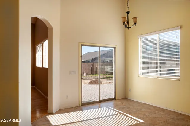 a view of an empty room with glass door
