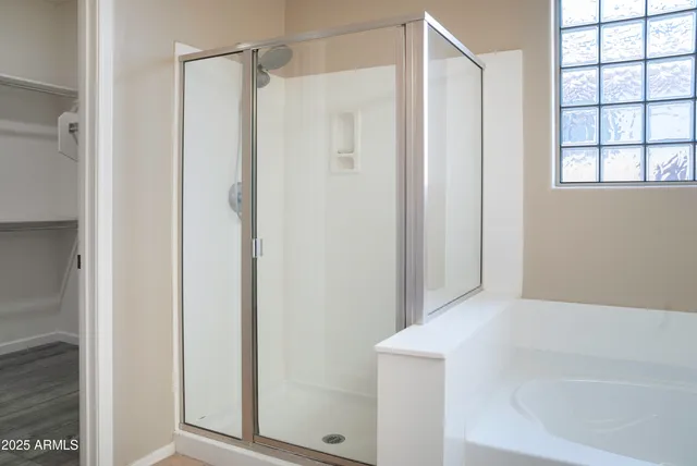 a bathroom with a shower and a tub