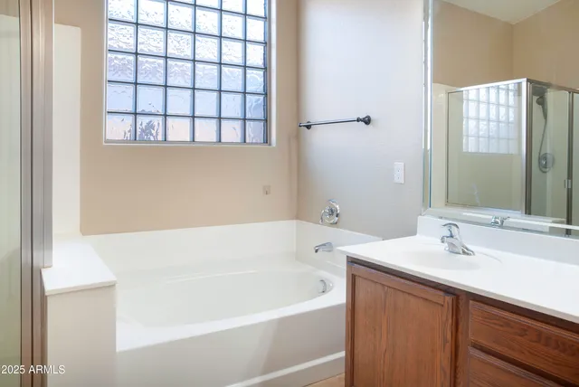 a white bath tub sitting next to a white sink