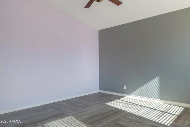 a view of a room with wooden floor