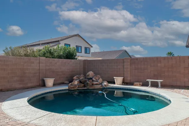 a view of a back yard with swimming pool