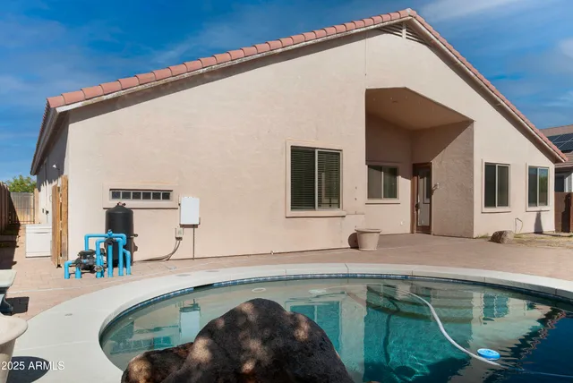 a swimming pool with outdoor seating