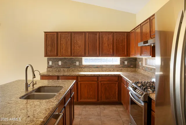 a kitchen with a sink stove and cabinets