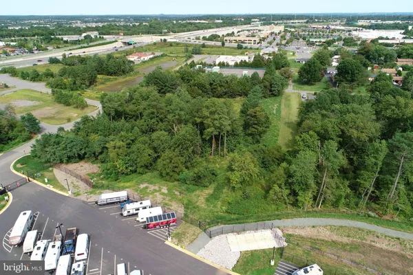 an aerial view of residential houses with outdoor space and trees